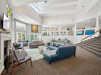 A living room with a fireplace and a blue couch.